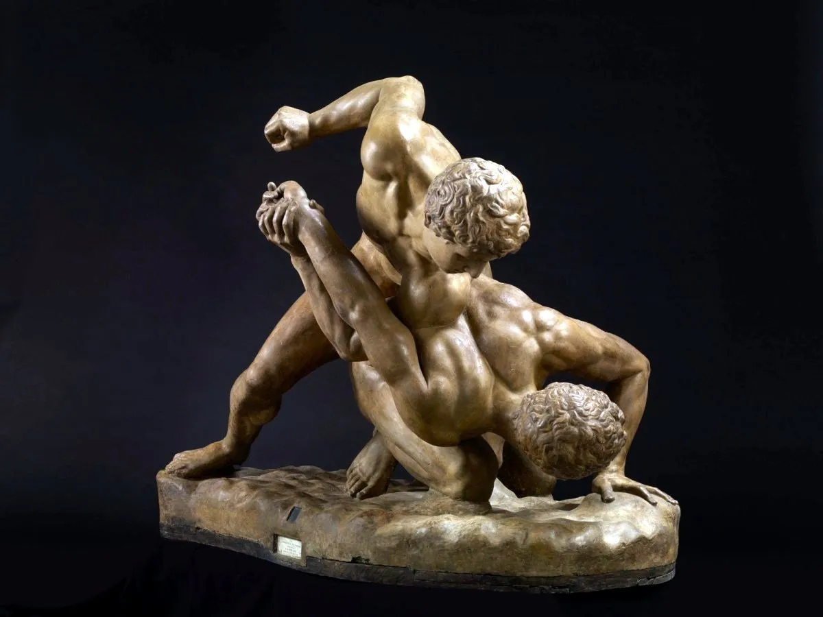 Bronze statue of two men wrestling