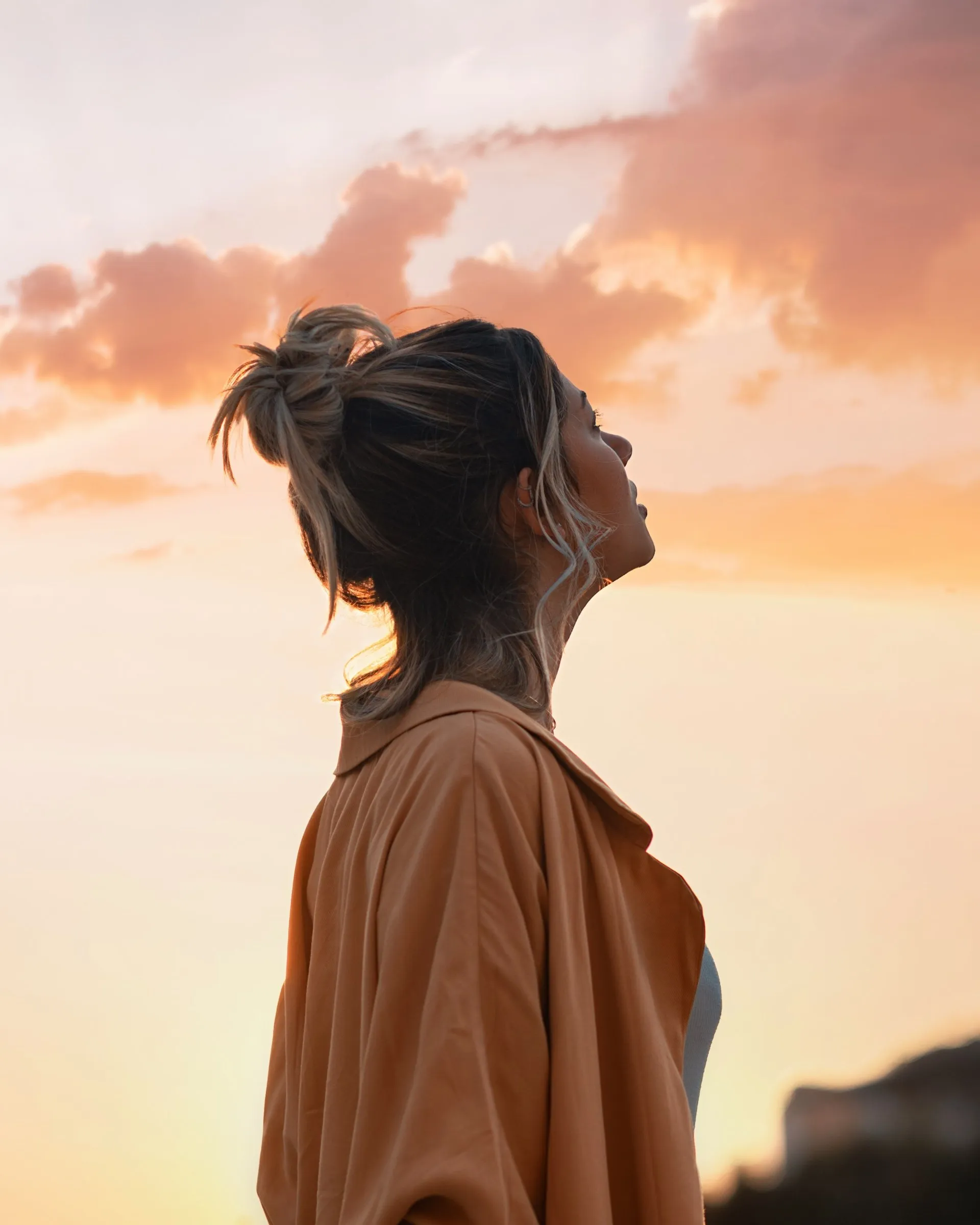 Woman looking into the clouds